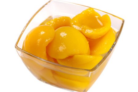 Tinned peach compote isolated on white background
